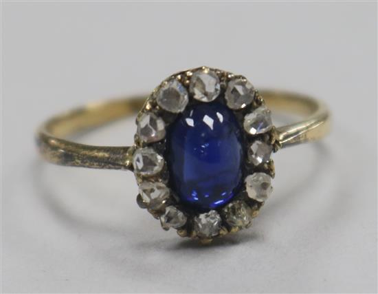 An early 20th century gold, cabochon sapphire and rose cut diamond set oval cluster ring, size O.